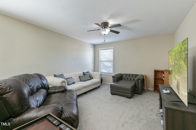 carpeted living area featuring ceiling fan and baseboards