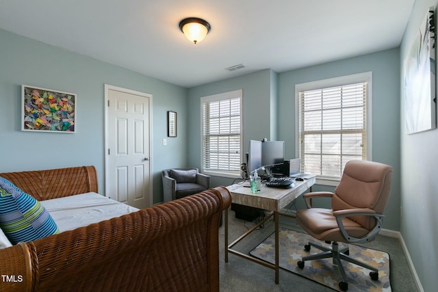 office space with carpet flooring, visible vents, and baseboards