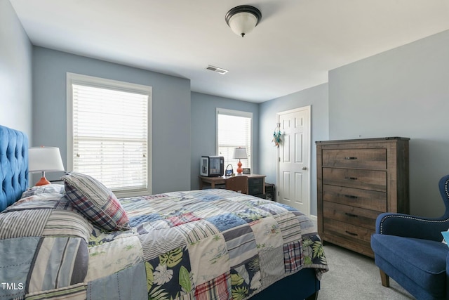 bedroom featuring carpet floors and visible vents