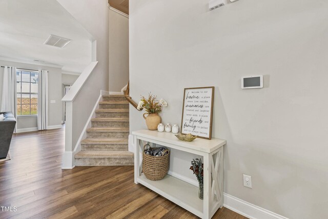 stairs with hardwood / wood-style flooring