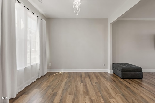 unfurnished room featuring a chandelier and dark hardwood / wood-style flooring