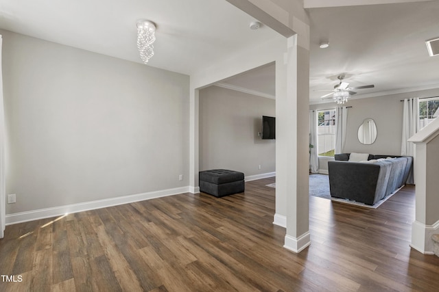 unfurnished living room with crown molding, ceiling fan, and dark hardwood / wood-style floors