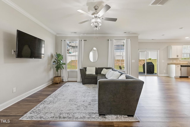 living room with hardwood / wood-style floors, ornamental molding, and ceiling fan