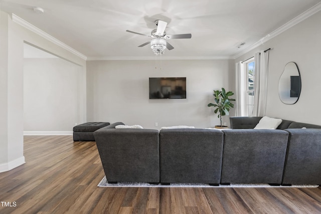 living room with hardwood / wood-style flooring, ceiling fan, and ornamental molding