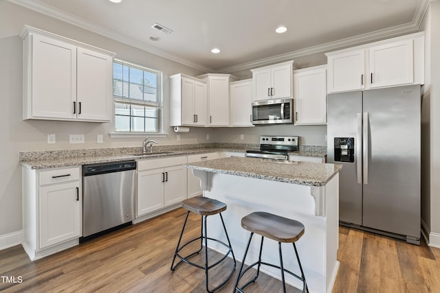 kitchen featuring stainless steel appliances and white cabinets