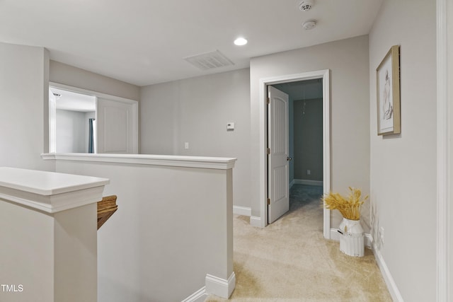 corridor featuring light colored carpet