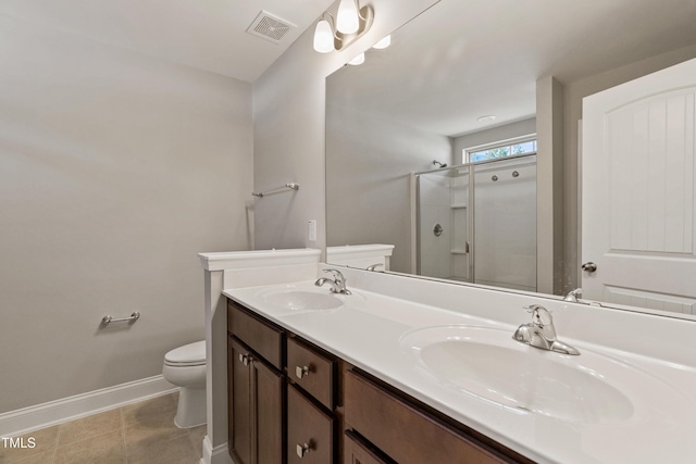 bathroom featuring vanity, tile patterned flooring, a shower with shower door, and toilet
