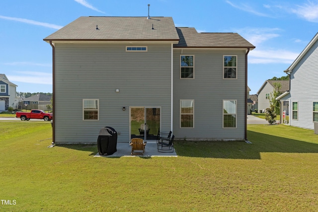 back of property with a yard and a patio area