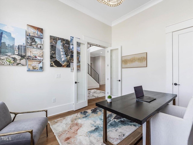 office with a city view, wood finished floors, baseboards, french doors, and ornamental molding