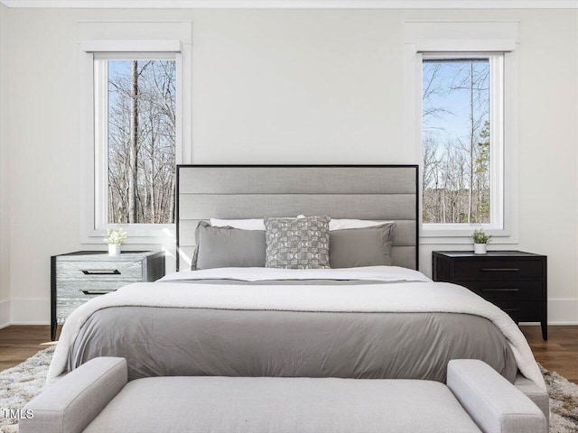 bedroom featuring dark wood-style flooring and baseboards