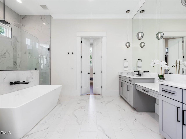 bathroom featuring a freestanding bath, marble finish floor, a marble finish shower, and vanity