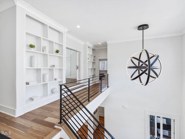 corridor with recessed lighting, crown molding, an upstairs landing, and wood finished floors