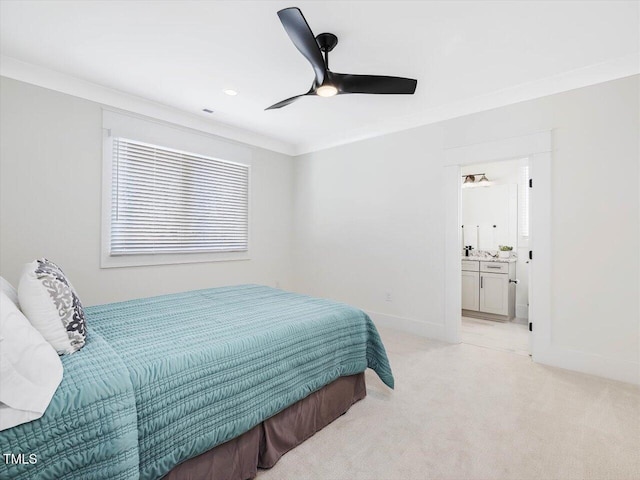 bedroom with light carpet, crown molding, ensuite bath, and baseboards