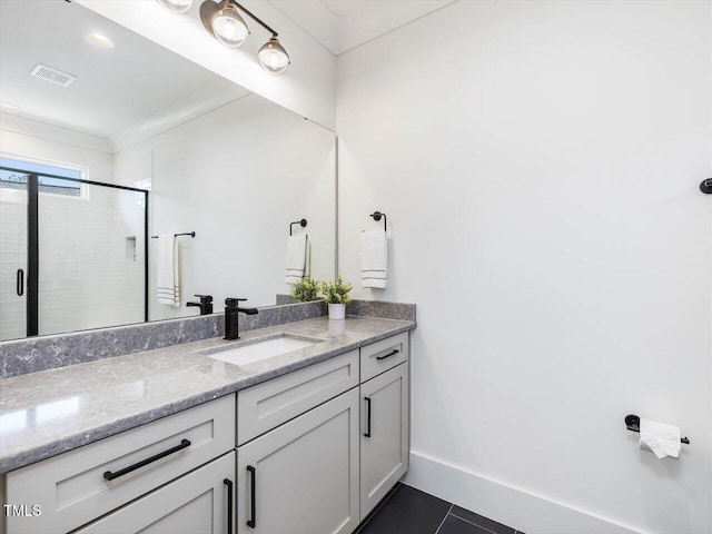 bathroom featuring visible vents, baseboards, tile patterned floors, vanity, and a shower stall