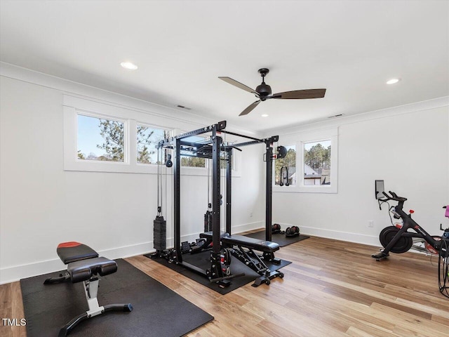 workout area with recessed lighting, ornamental molding, ceiling fan, wood finished floors, and baseboards