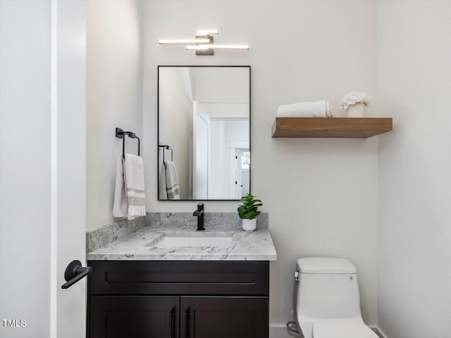 bathroom with toilet and vanity