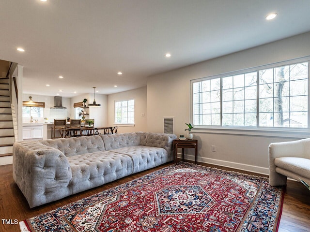 living room featuring baseboards, wood finished floors, visible vents, and recessed lighting