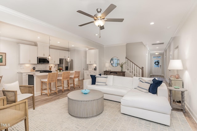349 Shadow Falls Dr, Wendell, NC 27591 - living area featuring light wood-type flooring, stairs, crown molding, a ceiling fan, and recessed lighting