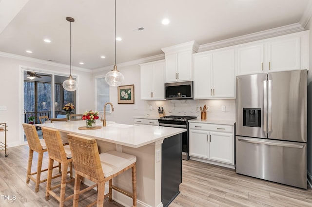 349 Shadow Falls Dr, Wendell, NC 27591 - kitchen with appliances with stainless steel finishes, a sink, light wood-type flooring, a center island with sink, and crown molding