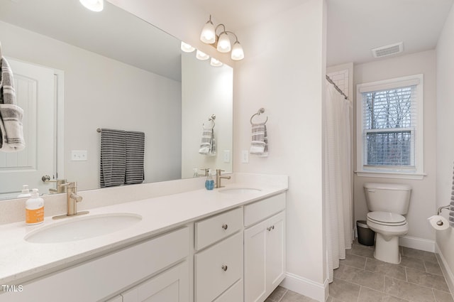 349 Shadow Falls Dr, Wendell, NC 27591 - bathroom featuring tile patterned floors, baseboards, double vanity, and toilet