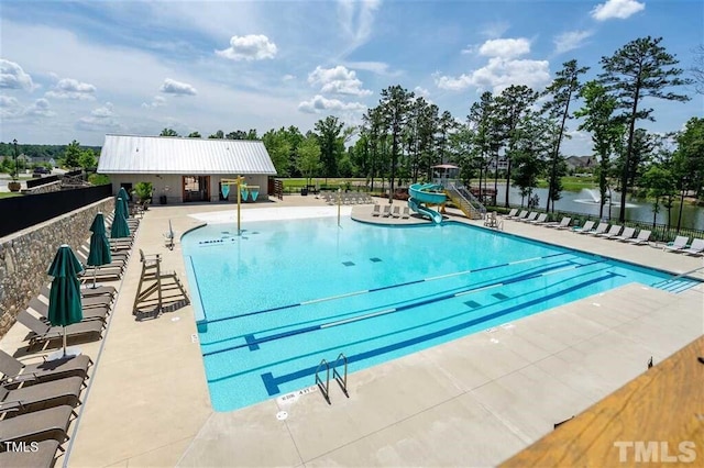 349 Shadow Falls Dr, Wendell, NC 27591 - community pool featuring a water slide, fence, and a patio