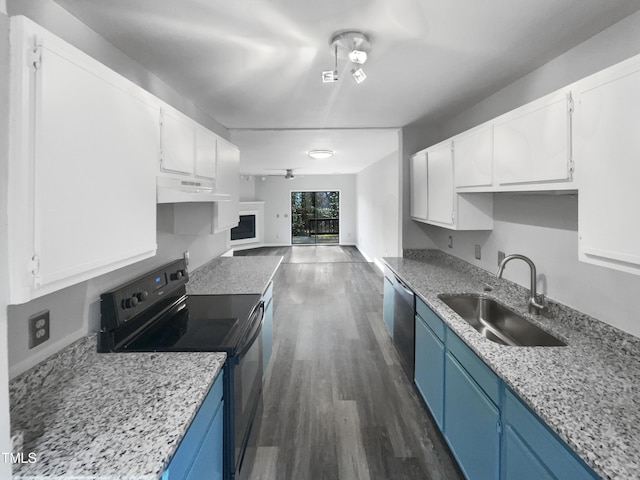 kitchen featuring black electric range oven, blue cabinetry, sink, and white cabinets