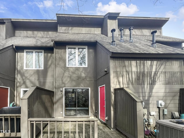 rear view of property featuring central air condition unit