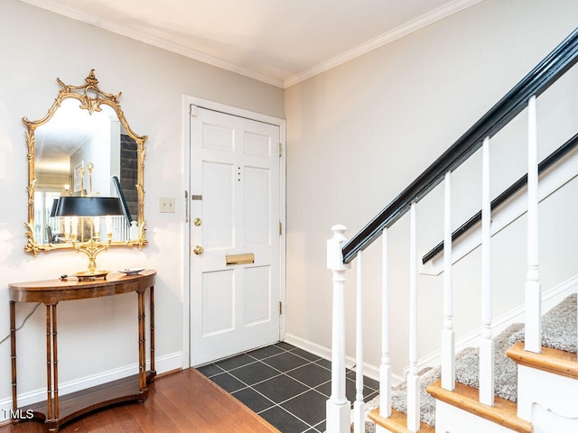 foyer featuring stairs, dark wood-style flooring, baseboards, and crown molding