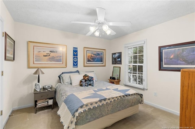 carpeted bedroom with ceiling fan and a textured ceiling