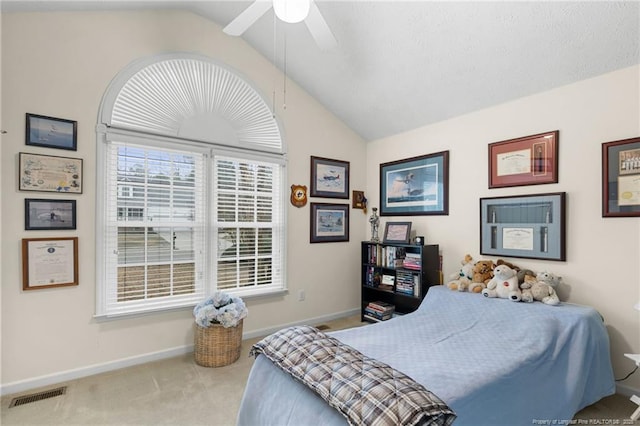 bedroom with ceiling fan, lofted ceiling, and carpet flooring