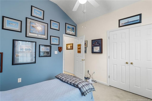 bedroom with lofted ceiling, light colored carpet, a closet, and ceiling fan