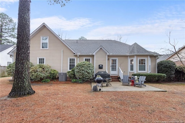 rear view of property featuring cooling unit and a patio area