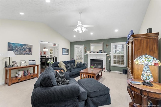 living room with vaulted ceiling, light colored carpet, and ceiling fan