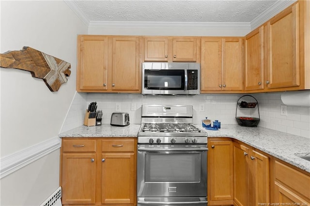 kitchen with crown molding, appliances with stainless steel finishes, light stone countertops, a textured ceiling, and decorative backsplash