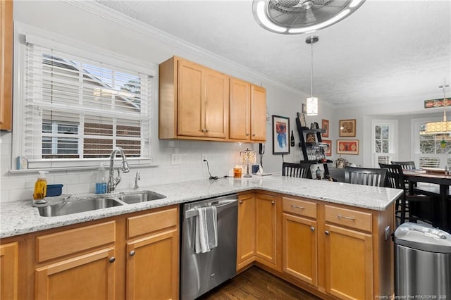 kitchen with stainless steel dishwasher, kitchen peninsula, sink, and hanging light fixtures