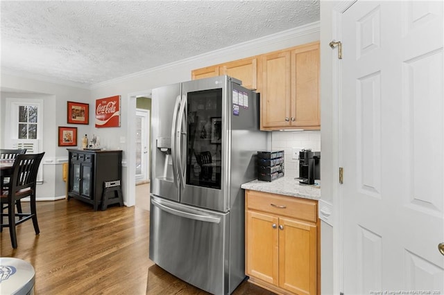 kitchen with light brown cabinetry, crown molding, stainless steel fridge, dark hardwood / wood-style flooring, and decorative backsplash