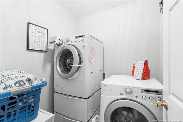 washroom featuring washer and dryer and a textured ceiling