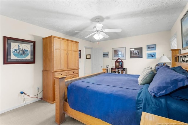 carpeted bedroom with ceiling fan and a textured ceiling