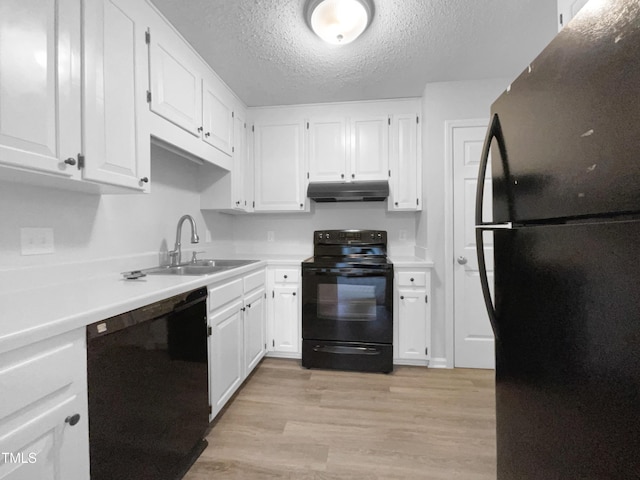 kitchen featuring sink, white cabinets, black appliances, a textured ceiling, and light hardwood / wood-style flooring