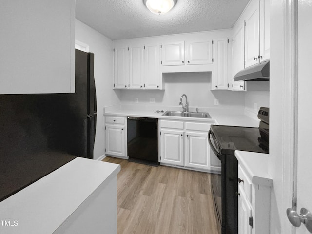 kitchen featuring white cabinetry, sink, light wood-type flooring, black appliances, and a textured ceiling