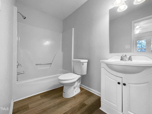 full bathroom featuring wood-type flooring, toilet, shower / bath combination, and vanity