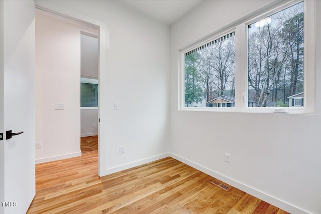 unfurnished room with light wood-type flooring