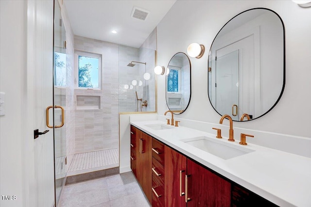 bathroom featuring vanity and a shower with shower door