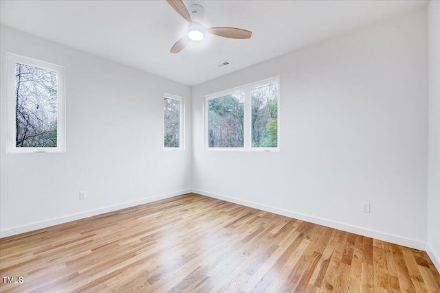 spare room with ceiling fan and light wood-type flooring