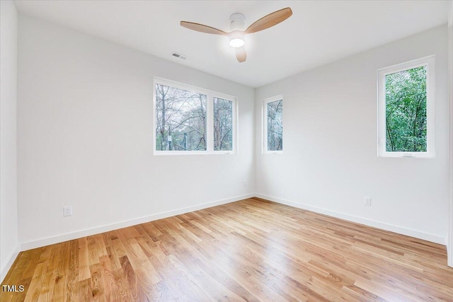 spare room with ceiling fan and light wood-type flooring