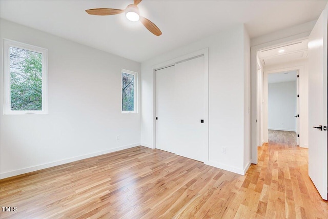 unfurnished bedroom featuring a closet, ceiling fan, and light wood-type flooring