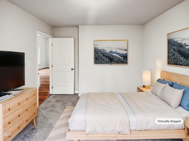 carpeted bedroom with a textured ceiling