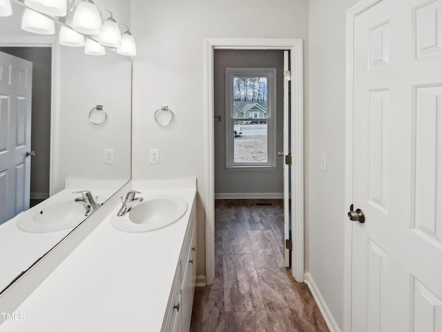 bathroom with an inviting chandelier and vanity