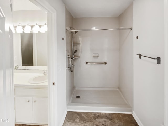 bathroom with vanity and a shower