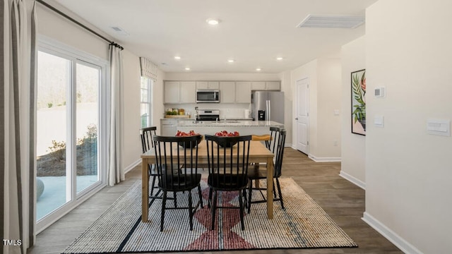 dining space featuring wood-type flooring